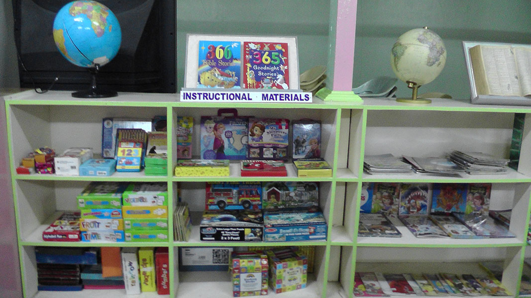 Shelves of instructional materials and globes