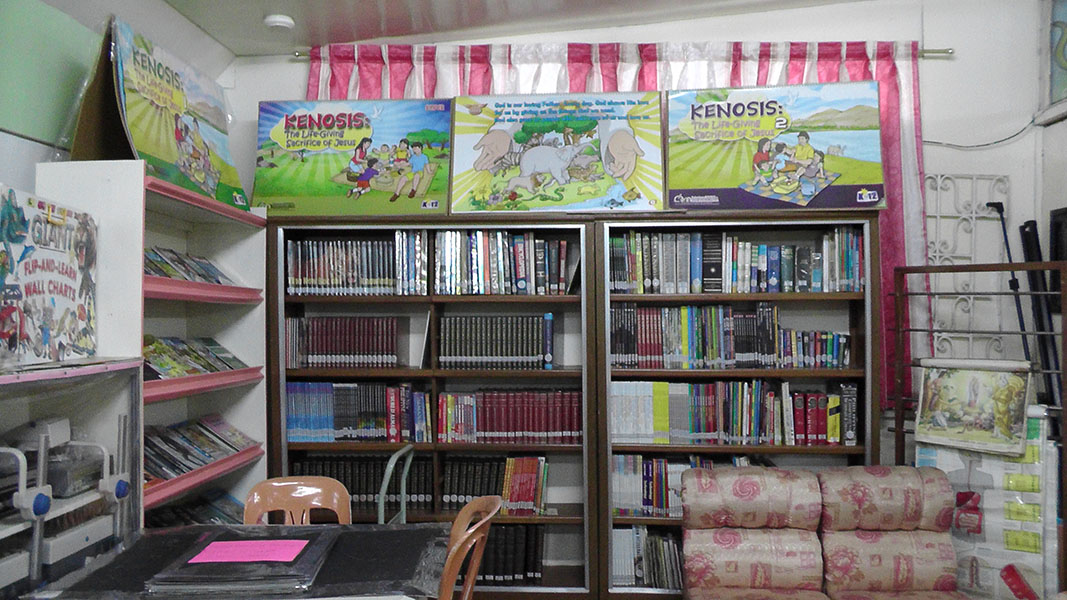 Bookshelves and children's posters in a reading area