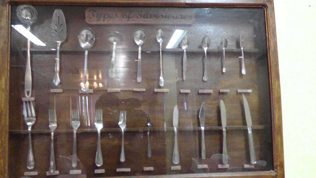 A display case of silverware and serving utensils
